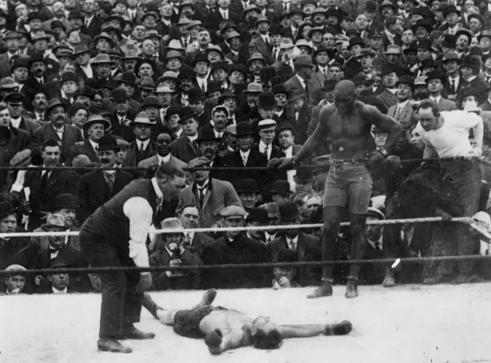 Jack Johnson in the ring after knocking down Stanley Ketchel, 1909