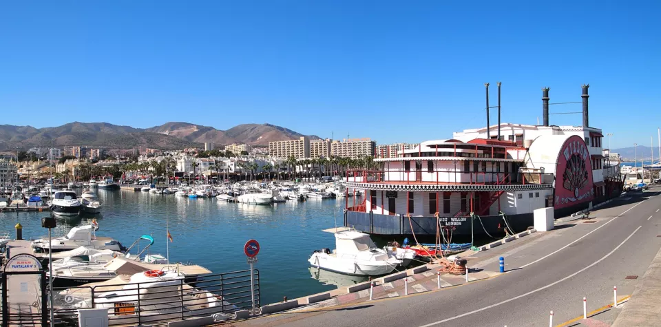 Marina with moored boats and waterfront buildings in Benalmádena, Spain