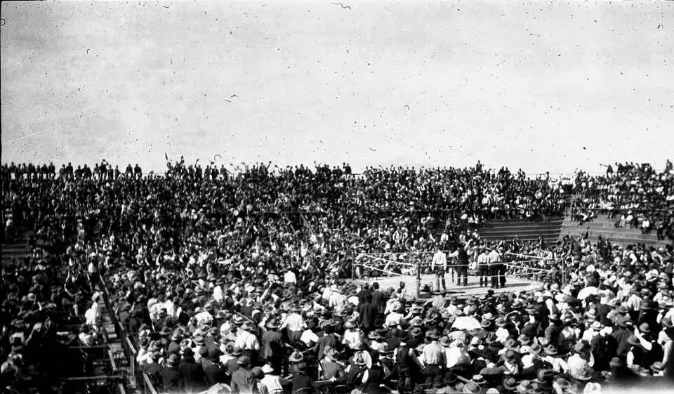 James J. Corbett and Bob Fitzsimmons boxing in an outdoor ring before a crowd