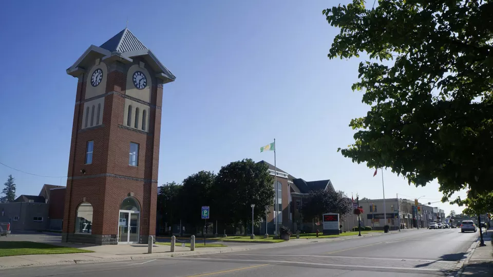 Main street of Hanover, Ontario, with shops and parked cars