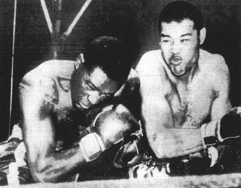 Ezzard Charles and Joe Louis fighting in the ring in 1950