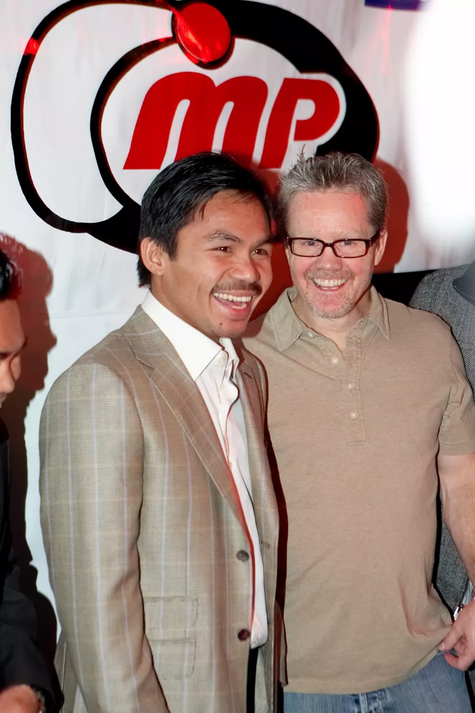 Freddie Roach and Manny Pacquiao standing together at a party