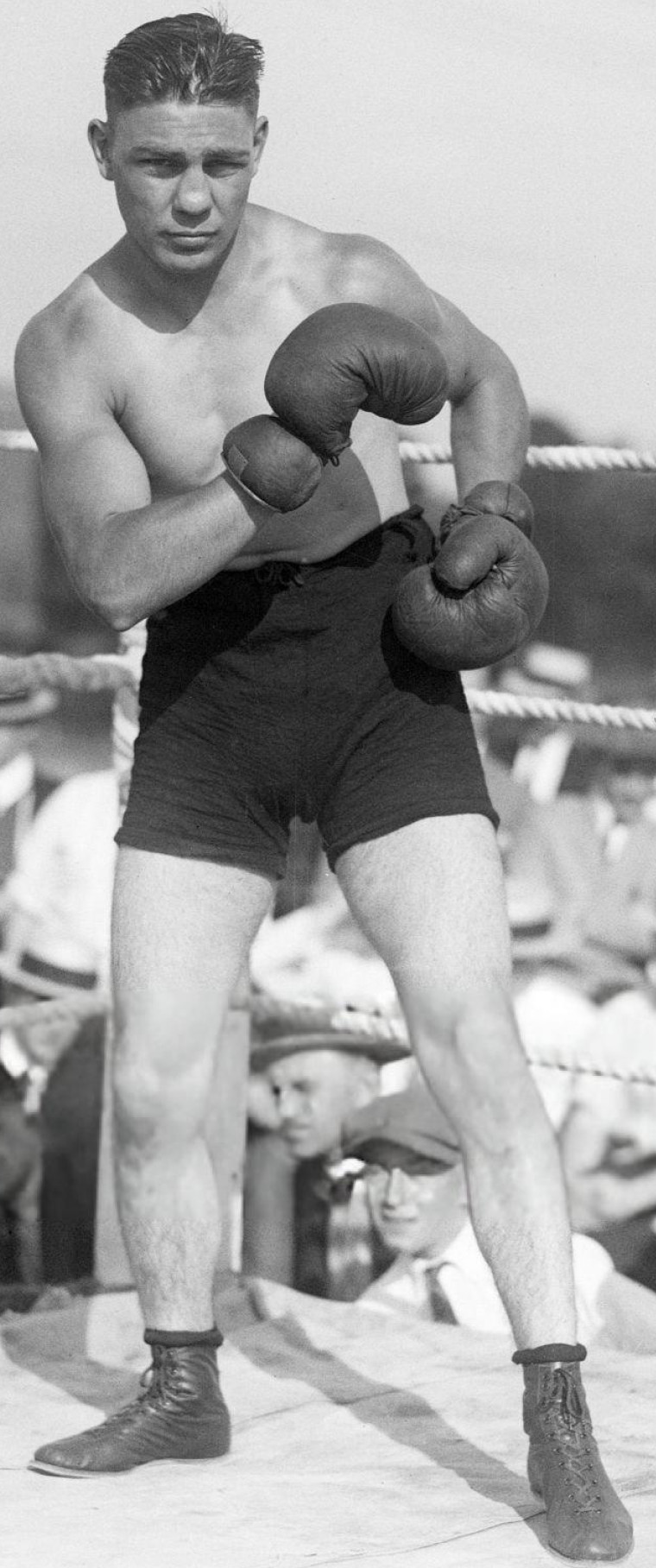 Black-and-white photo of boxer Harry Greb posing with his fists raised