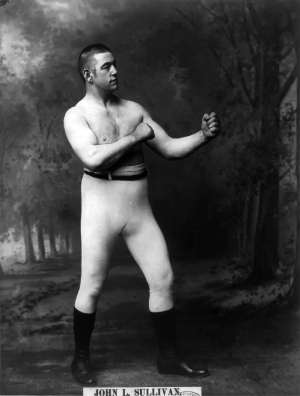 Studio portrait of boxer John L. Sullivan in ring attire