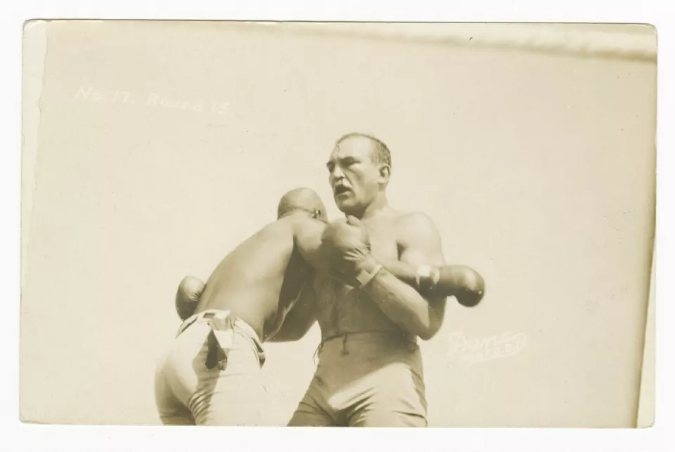 Jack Johnson and James J. Jeffries clinching in the ring, 1910