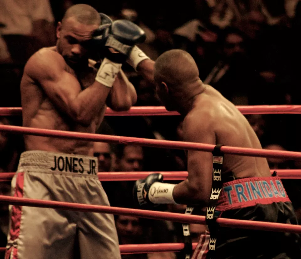 Félix Trinidad punching at Roy Jones Jr. in the ring in 2008