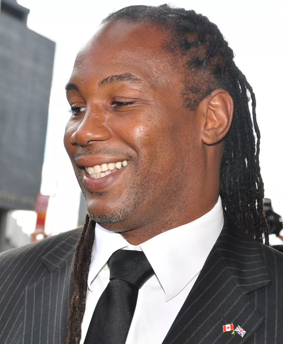 Lennox Lewis smiling at a public event in 2010