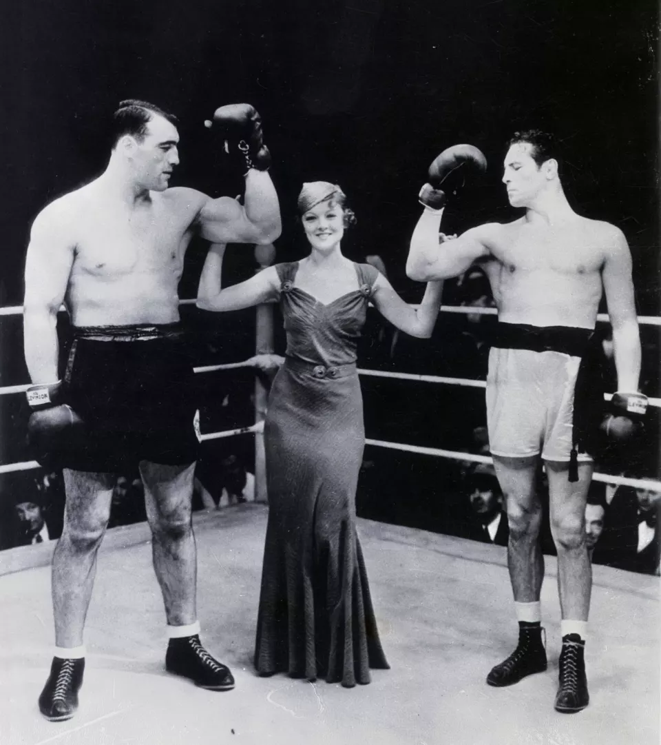 Max Baer and Primo Carnera standing beside actress Myrna Loy