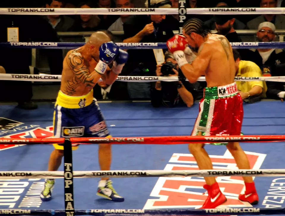 Miguel Cotto and Antonio Margarito exchanging punches in the ring at Madison Square Garden