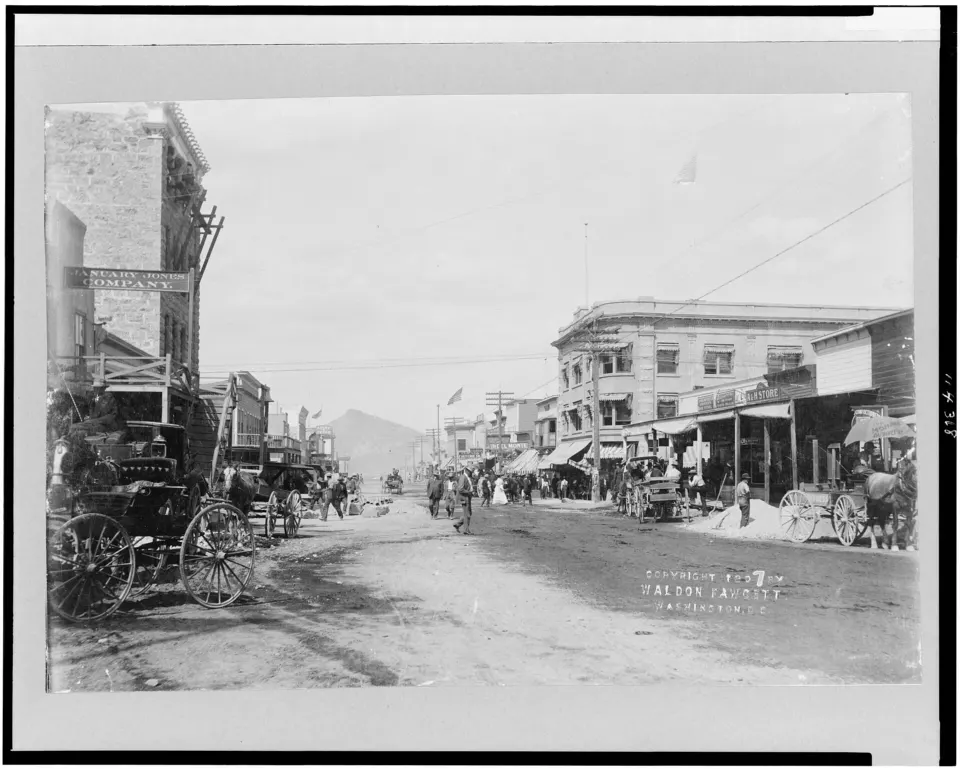 Busy main street of Goldfield, Nevada, with wooden and stone buildings