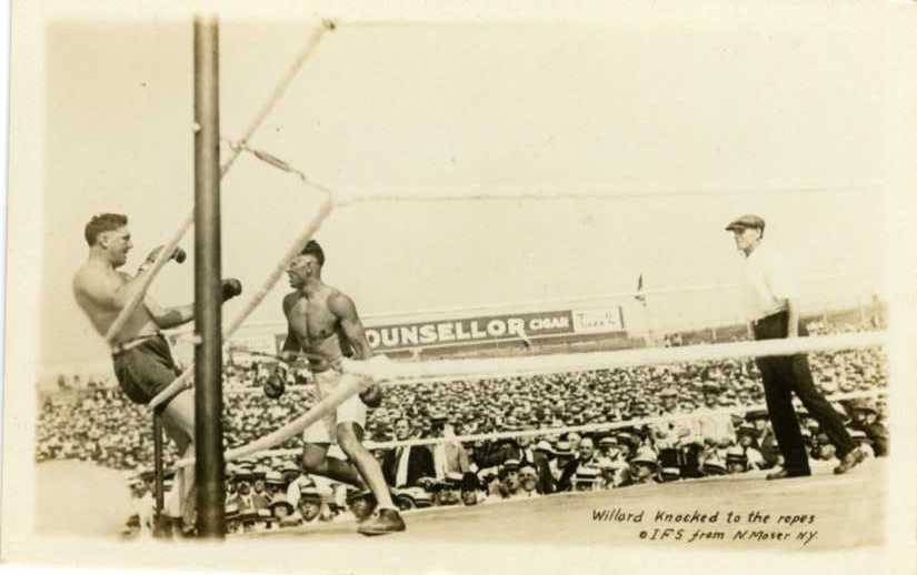 Jess Willard pushed back to the ropes by Jack Dempsey during their 1919 fight