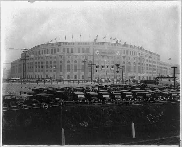Exterior of Yankee Stadium in the 1920s with cars parked in front